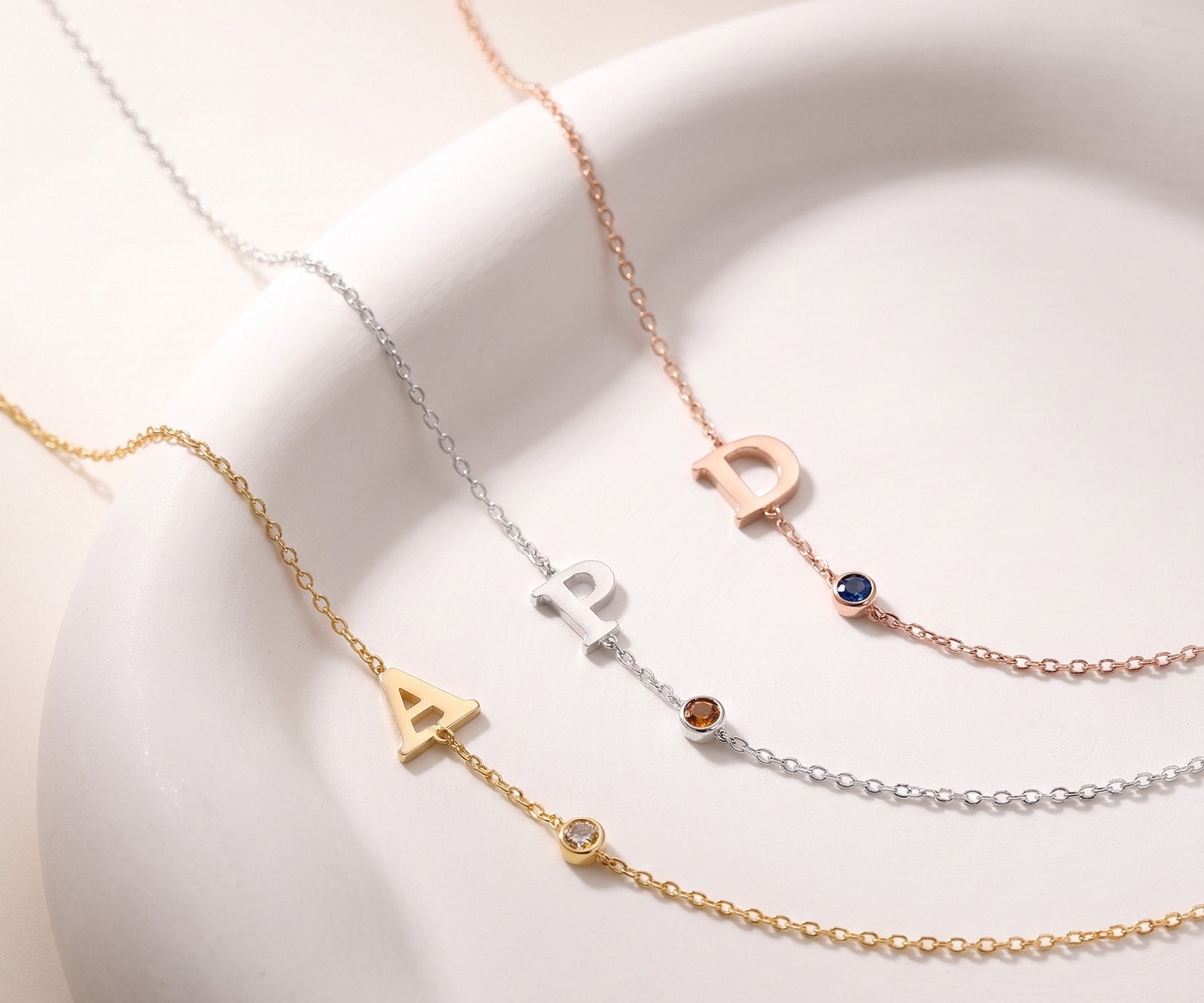 Initial necklaces with birthstones in gold, silver and rose gold